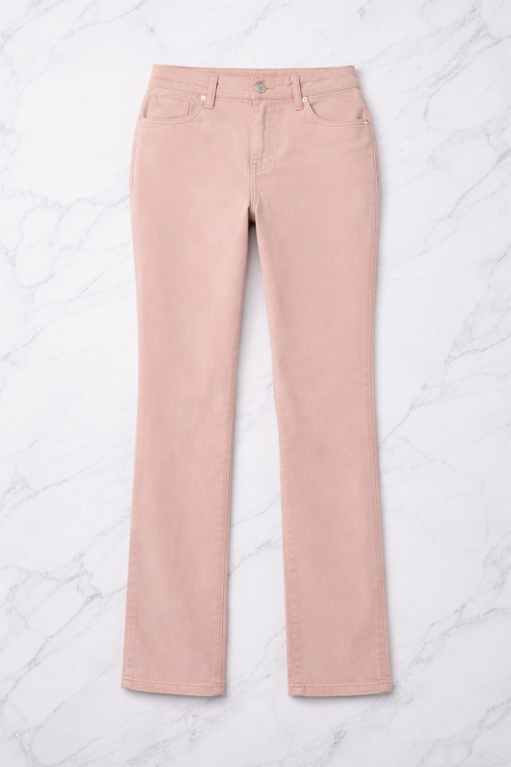 Pink jeans on a white quilted surface