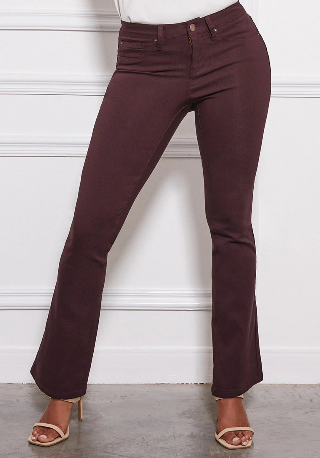 Maroon pants worn by a person against a white background