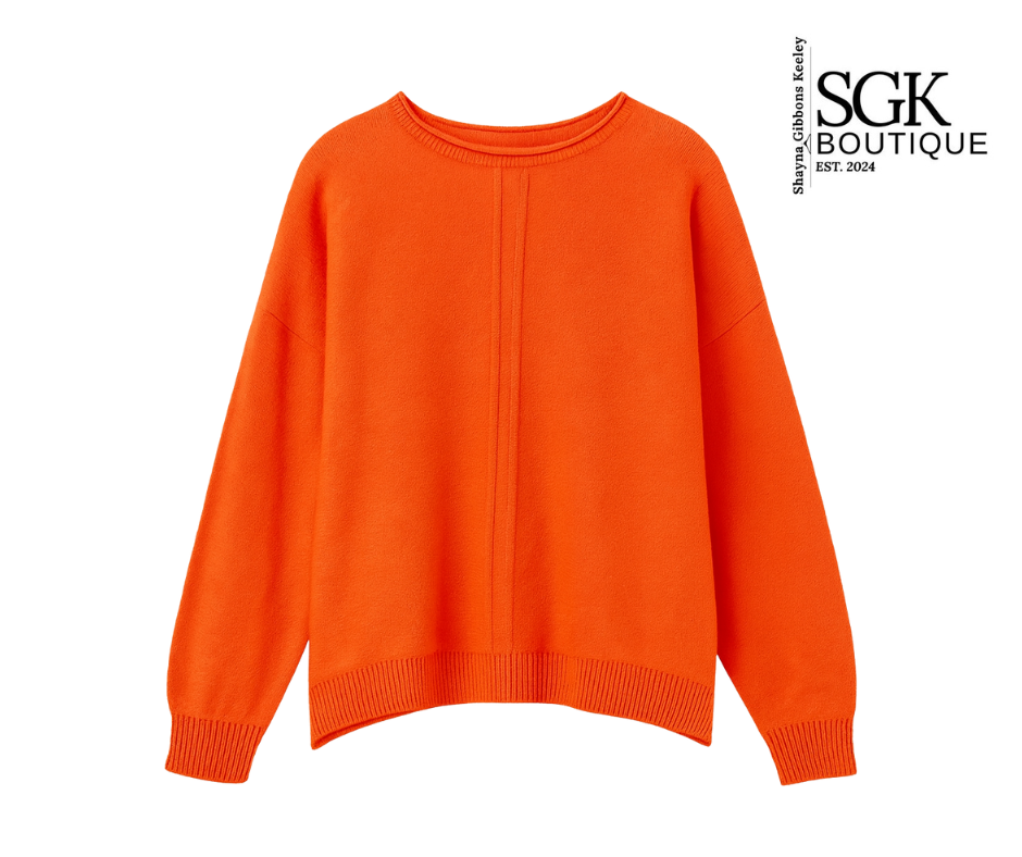 Orange sweater on a white background with SGK Boutique logo.