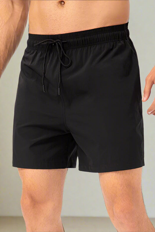 Black shorts with drawstring on a white background