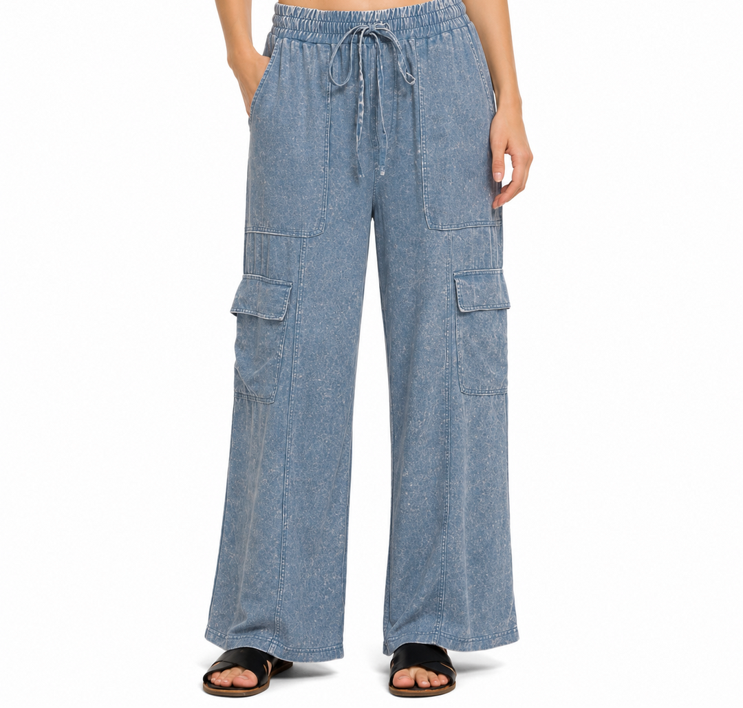 Blue denim cargo pants worn by a person on a white background