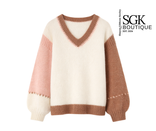 Color-blocked sweater with pink and brown accents on a white background, featuring the SGK Boutique logo.
