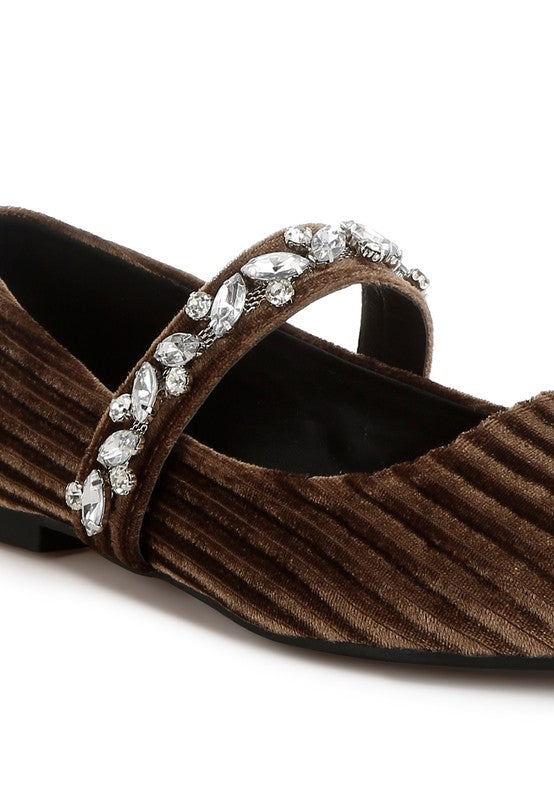 Brown shoe with decorative strap featuring crystals on a white background