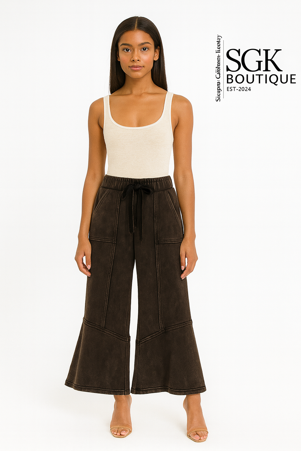 Woman wearing brown wide-leg pants and a beige tank top on a white background with SGK Boutique branding.