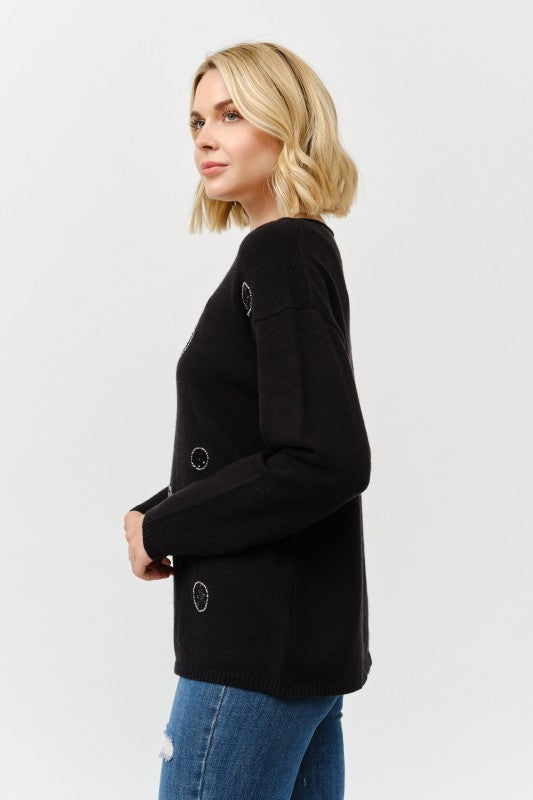 Woman wearing a black blazer with button details on a white background