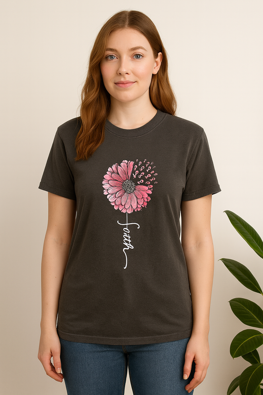Person wearing a dark gray t-shirt with a pink flower and 'faith' text design.