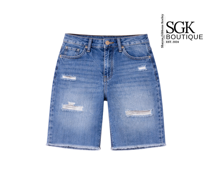 Blue denim shorts with distressed details on a white background, featuring the SGK Boutique logo.