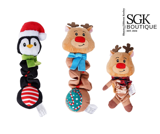 Two reindeer toys and a penguin toy with festive accessories on a white background, branded with SGK Boutique.
