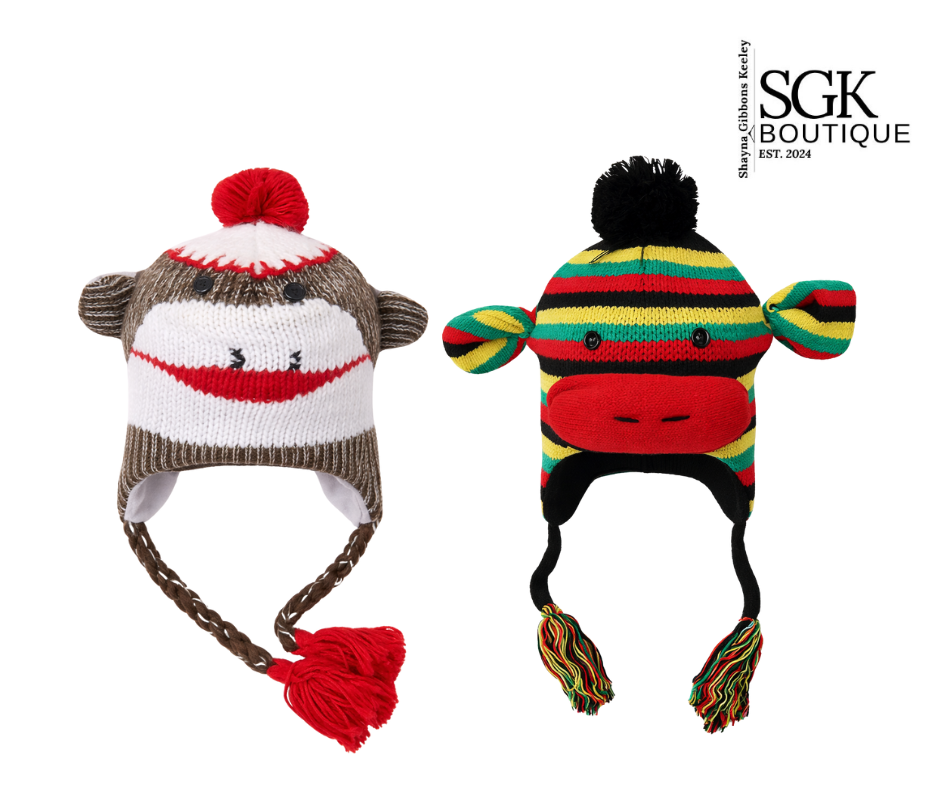 Two knitted monkey hats with pom-poms on a white background, featuring the SGK Boutique logo.