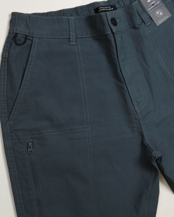 Navy blue shorts with a tag on a light gray background