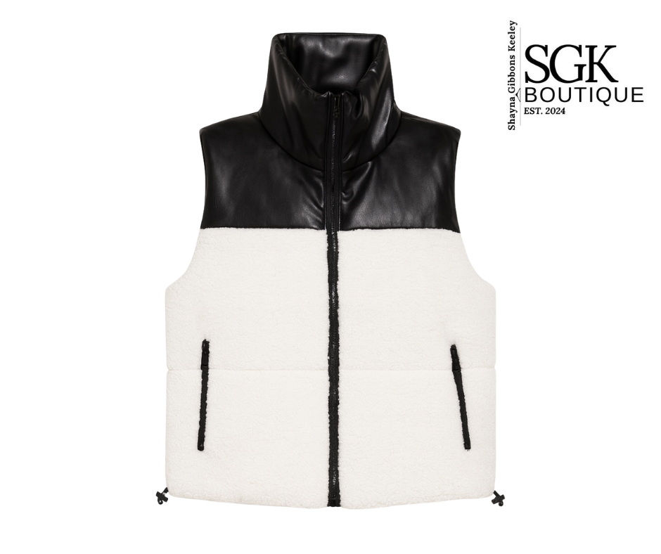 Black and white puffer vest with SGK Boutique logo on a white background