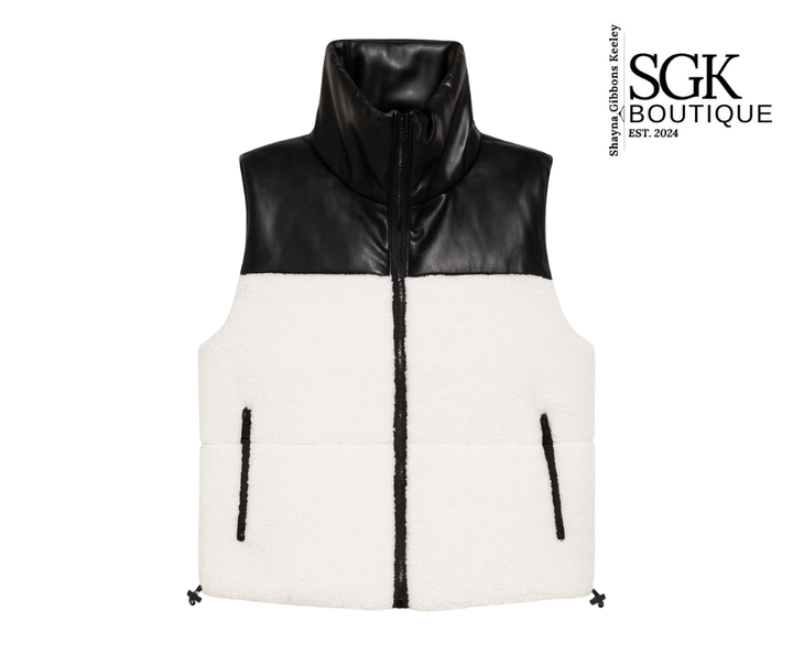 Black and white puffer vest with SGK Boutique logo on a white background