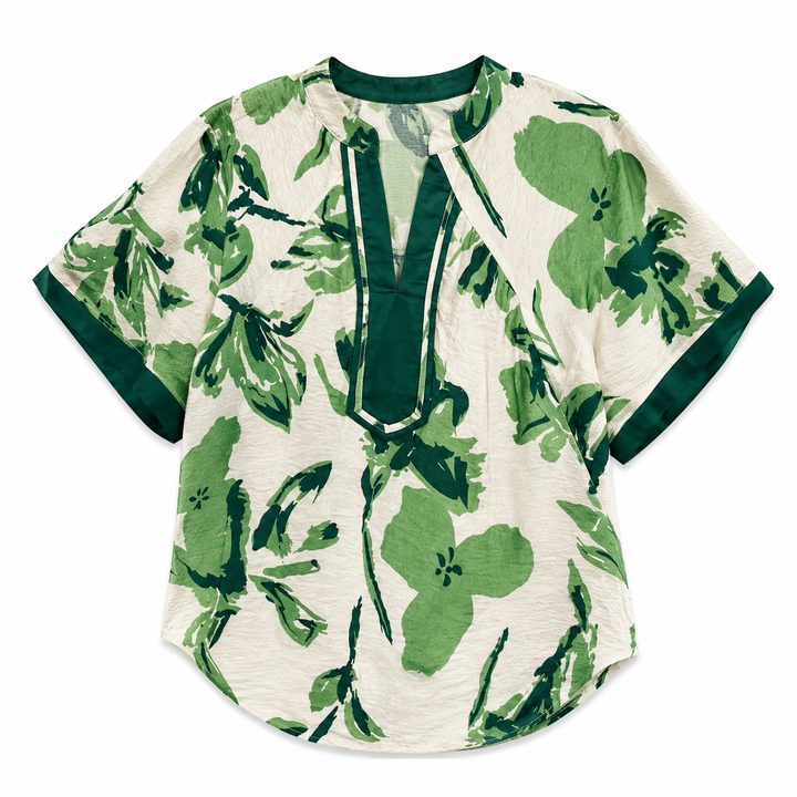A short-sleeve blouse with a green floral and leaf print on an off-white background, featuring a dark green split neckline and sleeve trim.