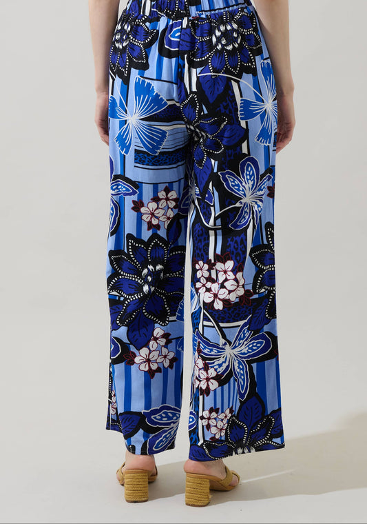 Blue floral patterned pants worn by a person on a light background
