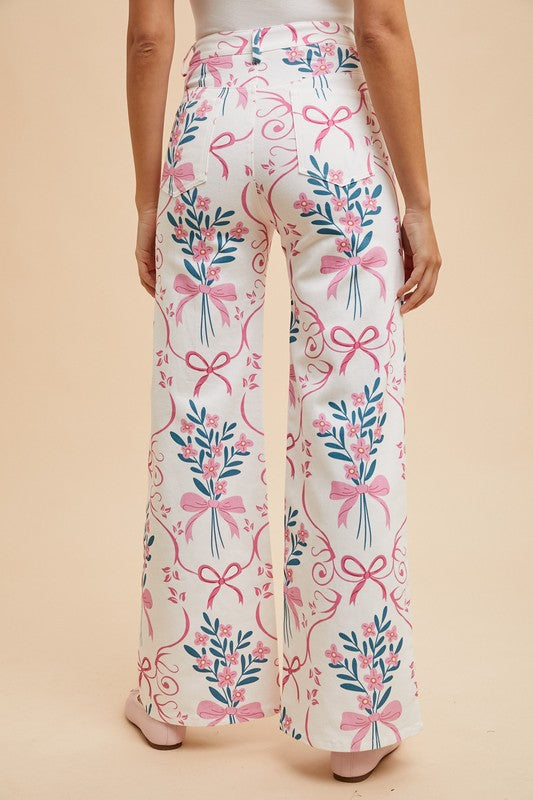 Floral and bow-patterned pants on a beige background