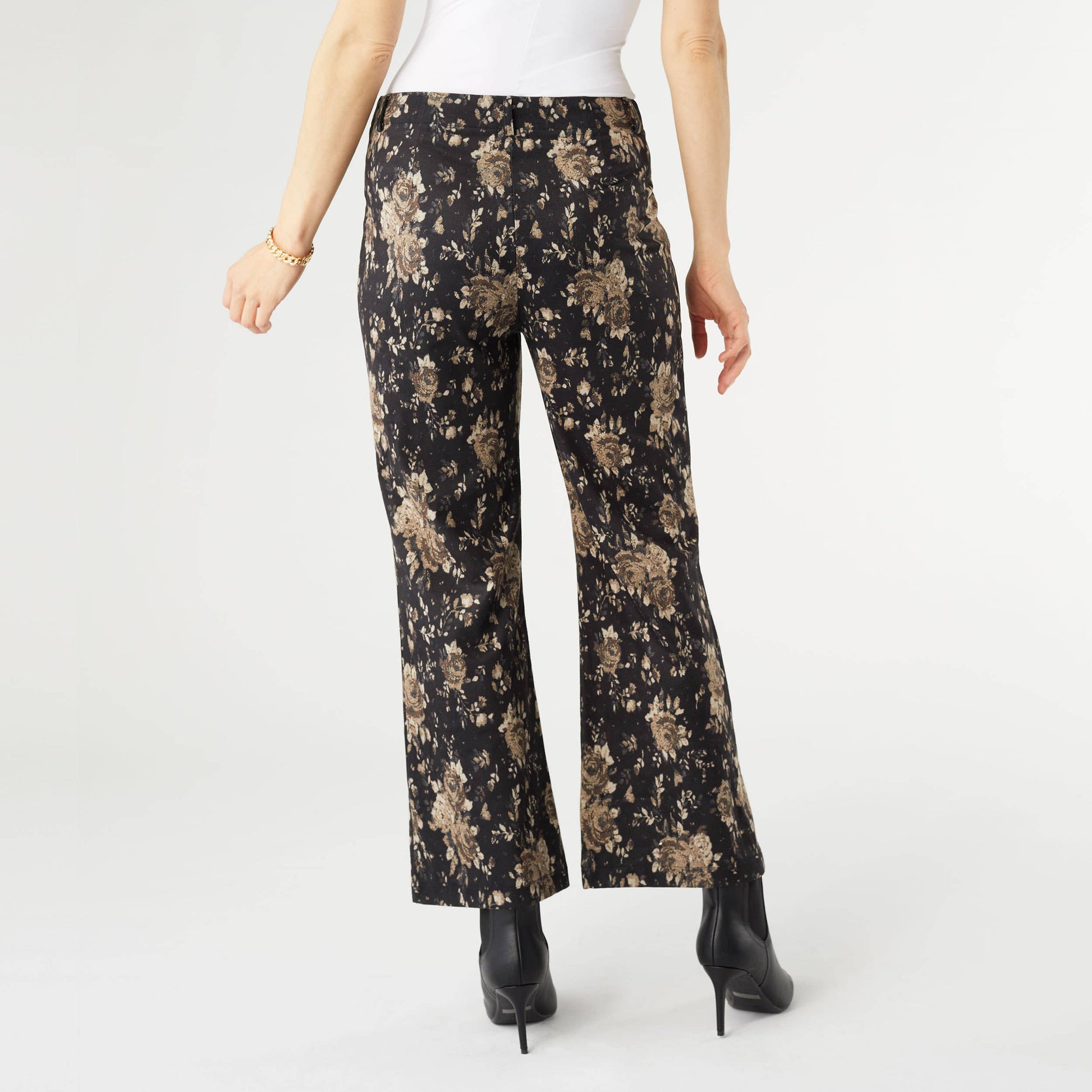 Floral-patterned pants worn by a person on a white background