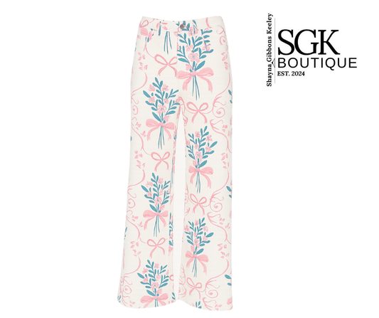 Floral and bow-patterned pants with SGK Boutique branding on a white background