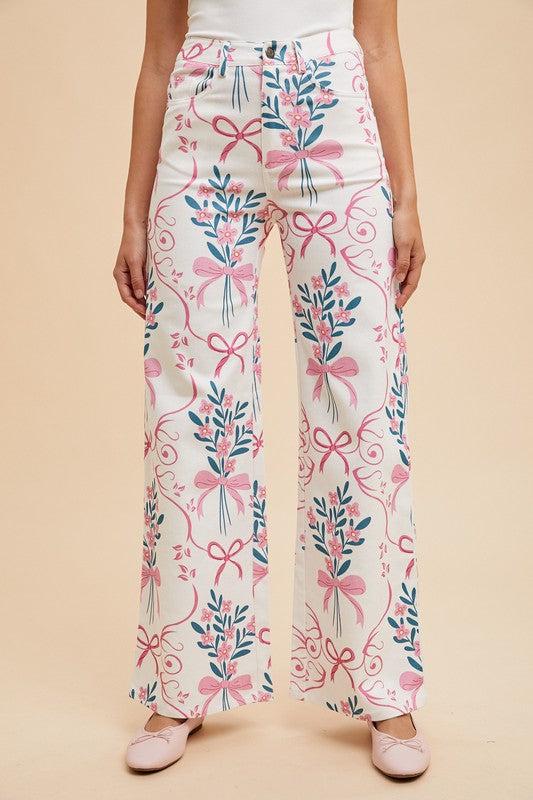 Floral and bow-patterned pants on a beige background