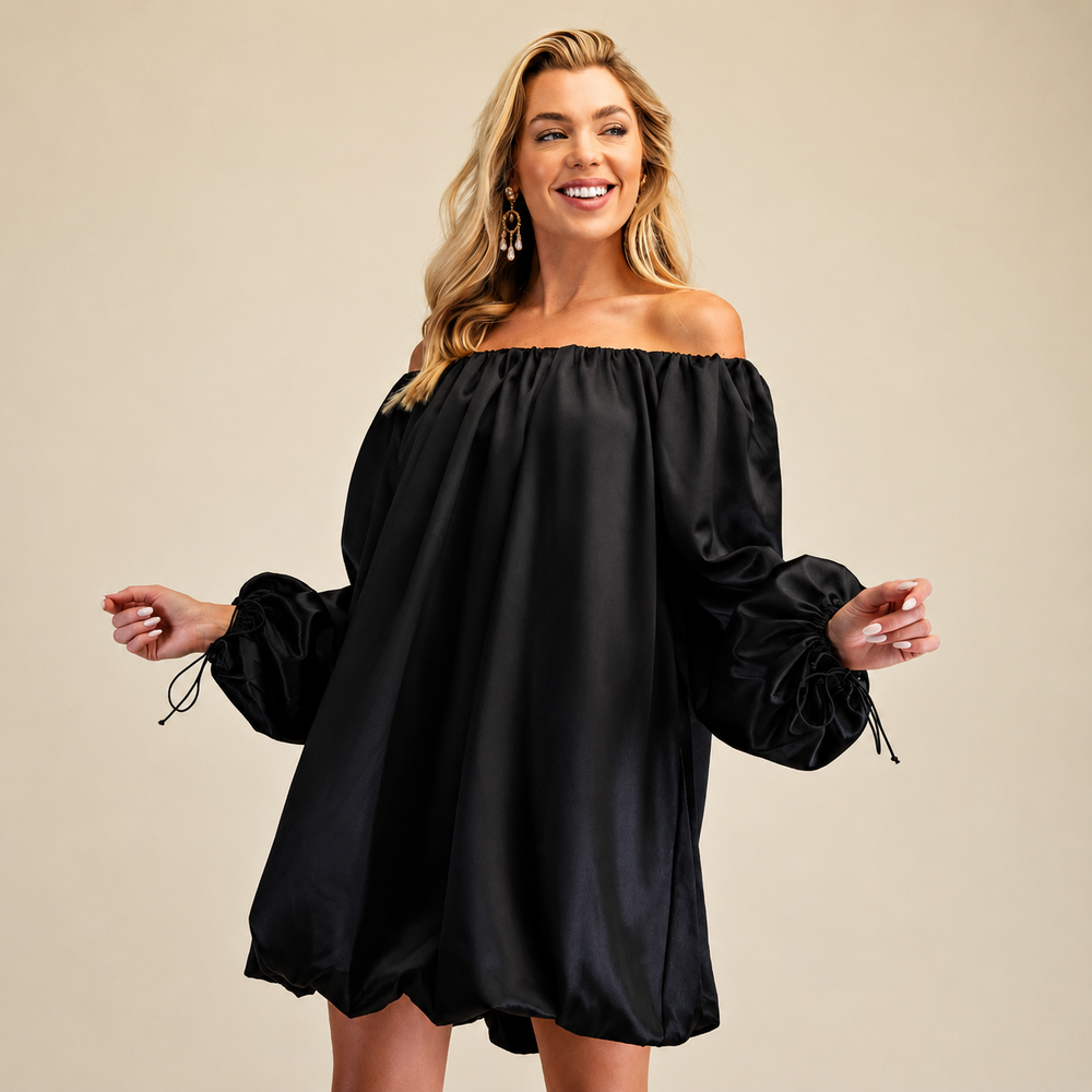 Woman wearing a black off-shoulder dress on a beige background