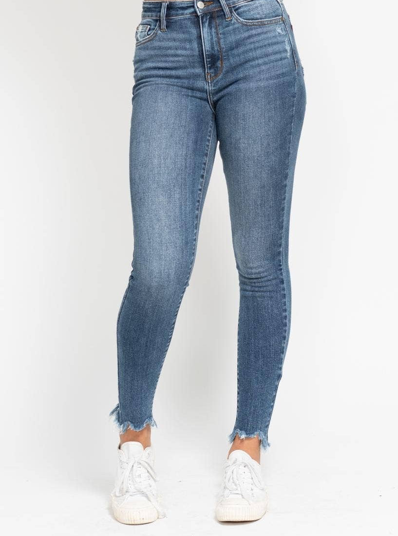 Blue jeans worn by a person on a white background