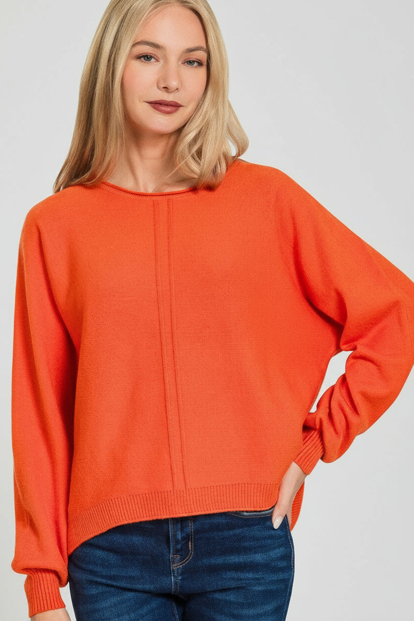 Woman wearing a burnt orange sweater on a white background