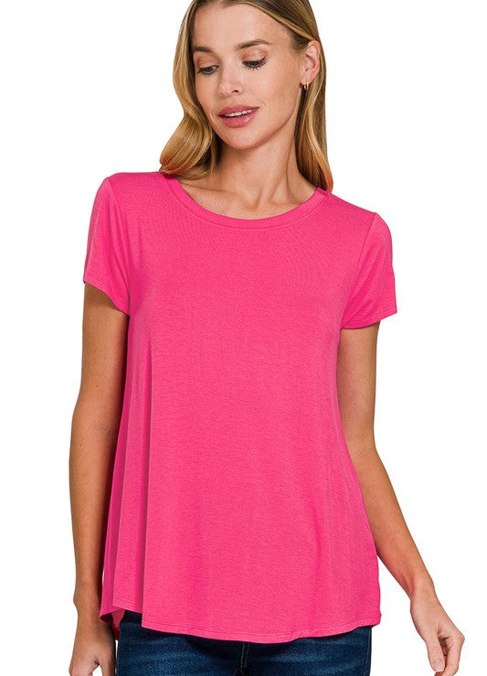 Woman wearing a bright pink t-shirt on a white background