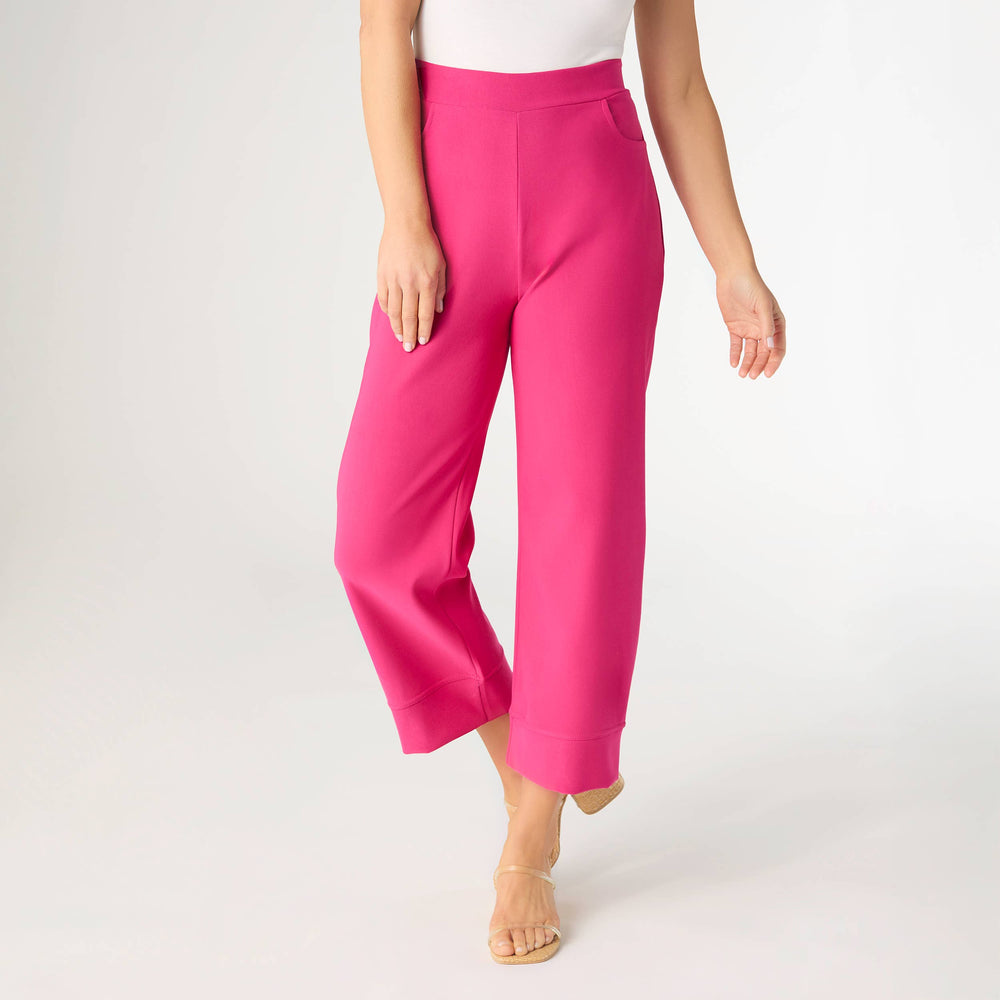 Person wearing bright pink pants on a white background