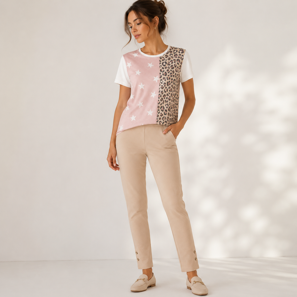 Woman wearing a patterned top and beige pants on a white background