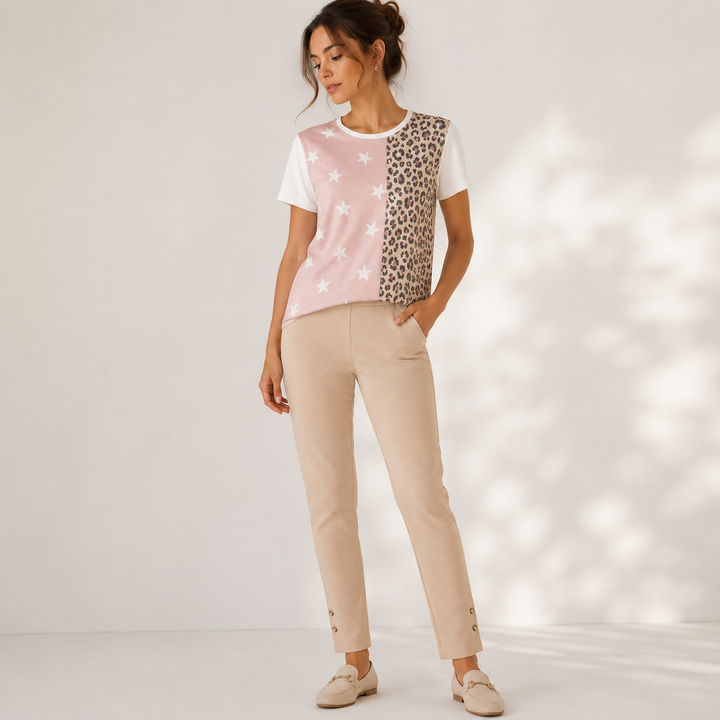Woman wearing a patterned top and beige pants on a white background