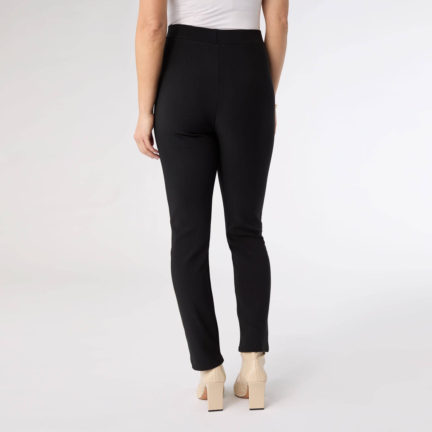 Person wearing black pants on a white background