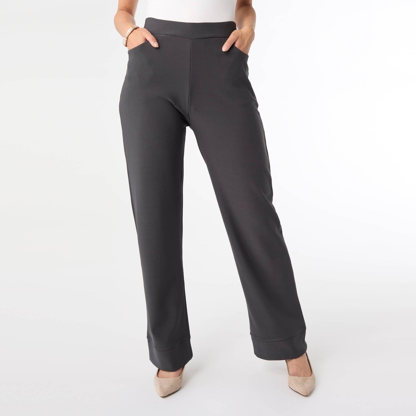 Dark gray pants worn by a person on a white background