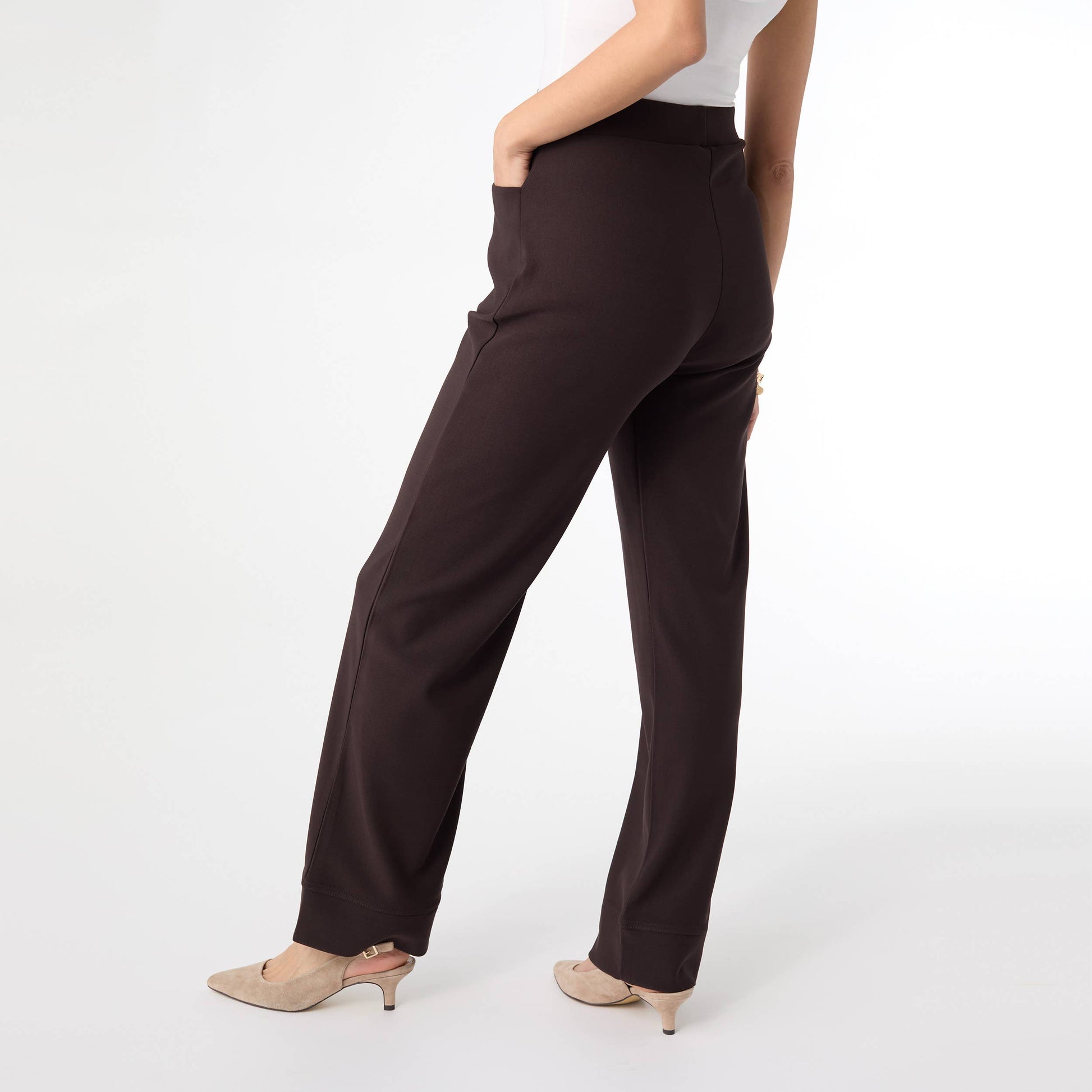 Brown pants worn by a person on a white background