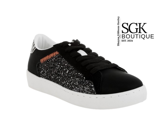 Black sneaker with glittery panel on a white background, featuring SGK Boutique branding.