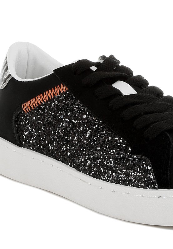 Black glittery sneaker with white sole on a white background