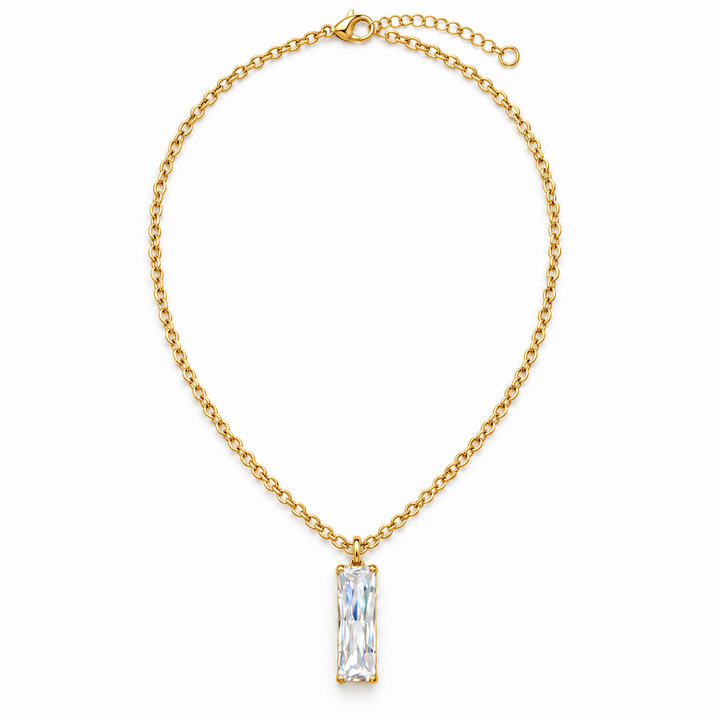 A gold chain necklace with a rectangular clear iridescent crystal pendant, displayed on a clean white background.