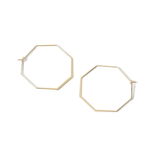 Hexagonal gold hoop earrings on a white background