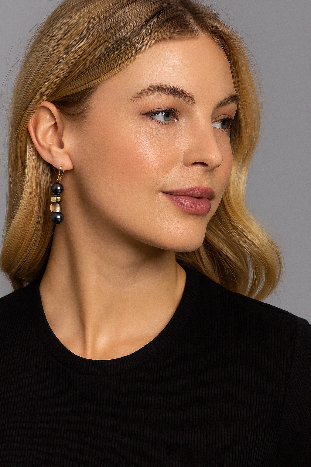 Woman wearing earrings with a neutral background