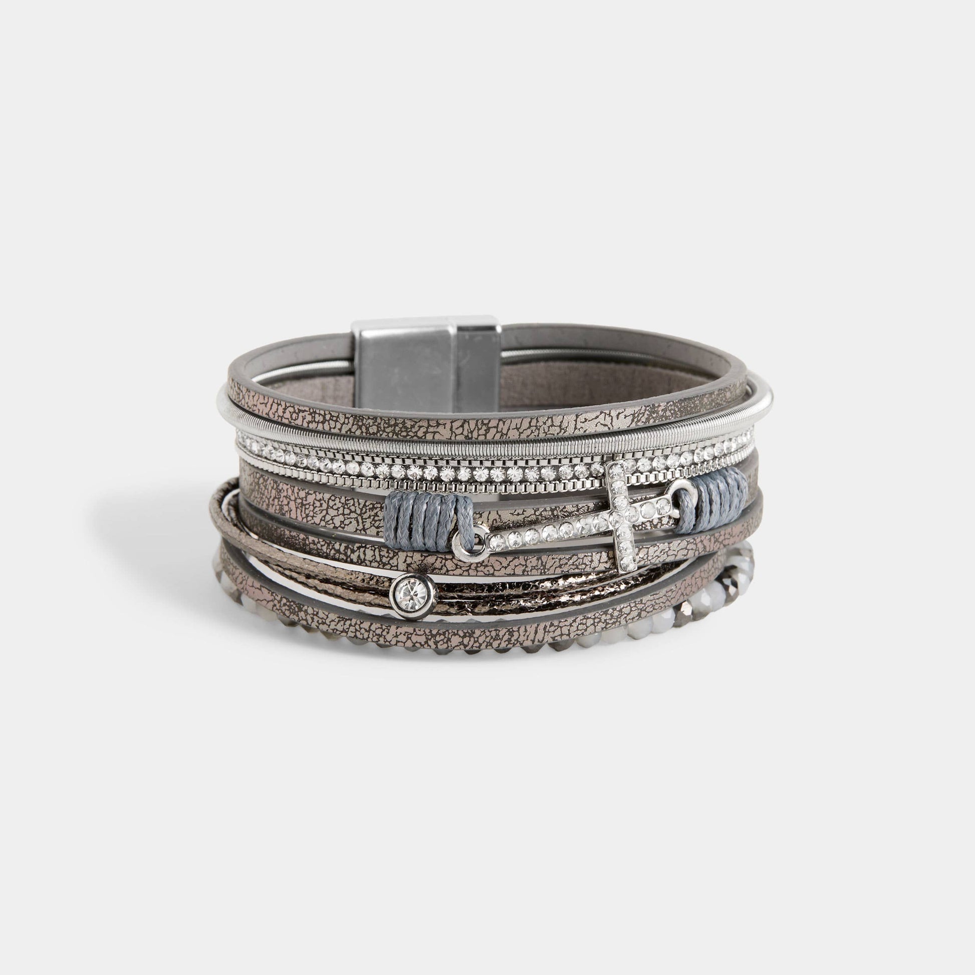 Multi-layered bracelet with metallic and textured design on a light gray background