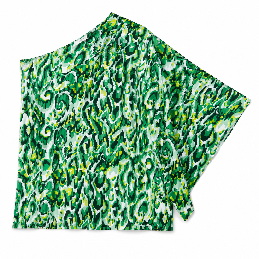 A lightweight fabric garment, likely a poncho or cape, featuring a vibrant green and white abstract organic pattern with small yellow accents, displayed on a clean white background.