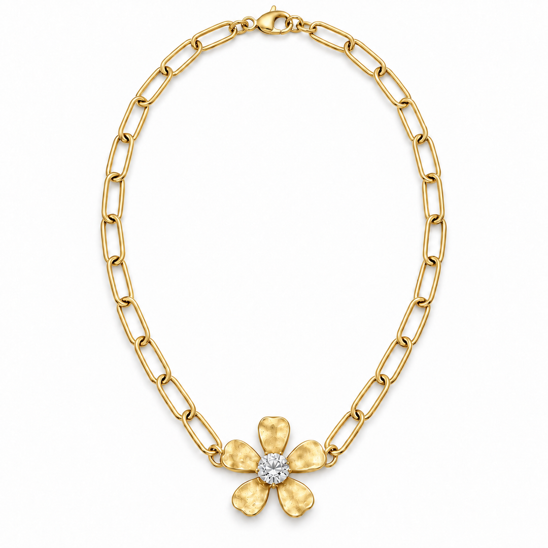 A yellow gold chain necklace featuring a textured five-petal flower pendant with a clear round-cut center stone, displayed on a clean white background.