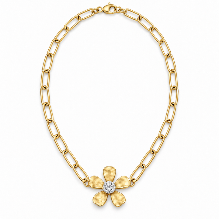 A yellow gold chain necklace featuring a textured five-petal flower pendant with a clear round-cut center stone, displayed on a clean white background.