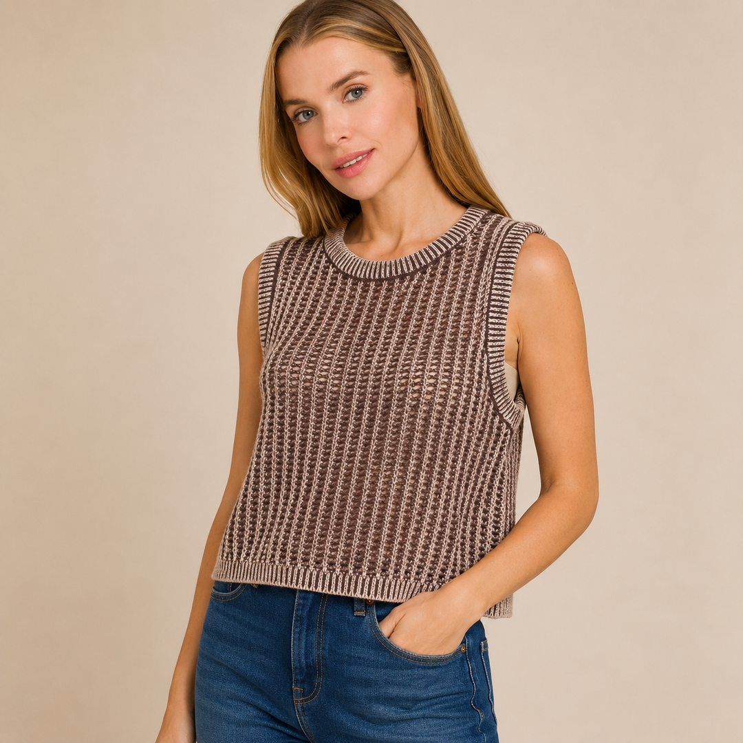 Woman wearing a sleeveless patterned top against a beige background