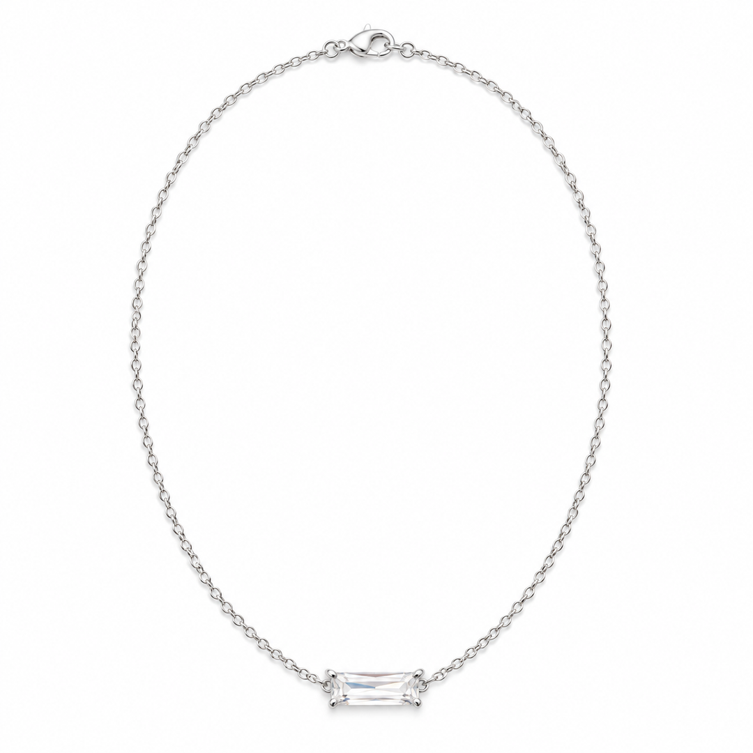 A silver chain necklace with a rectangular baguette-cut clear gemstone set in a four-prong setting, displayed on a clean white background.