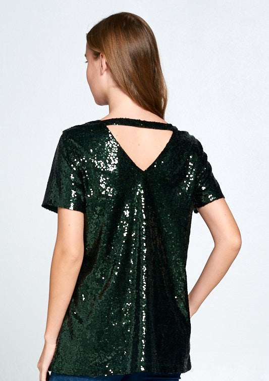 Woman wearing a green sequin top on a white background