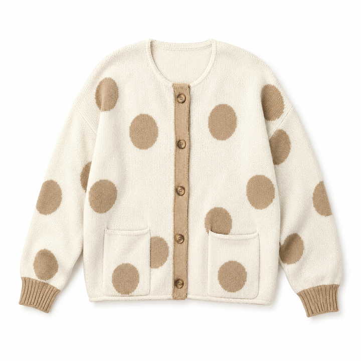 An off-white knit cardigan sweater with large tan polka dots, a tan button placket, and two front patch pockets, shown flat against a white background.