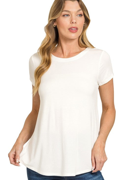 Woman wearing an ivory t-shirt and blue jeans on a white background