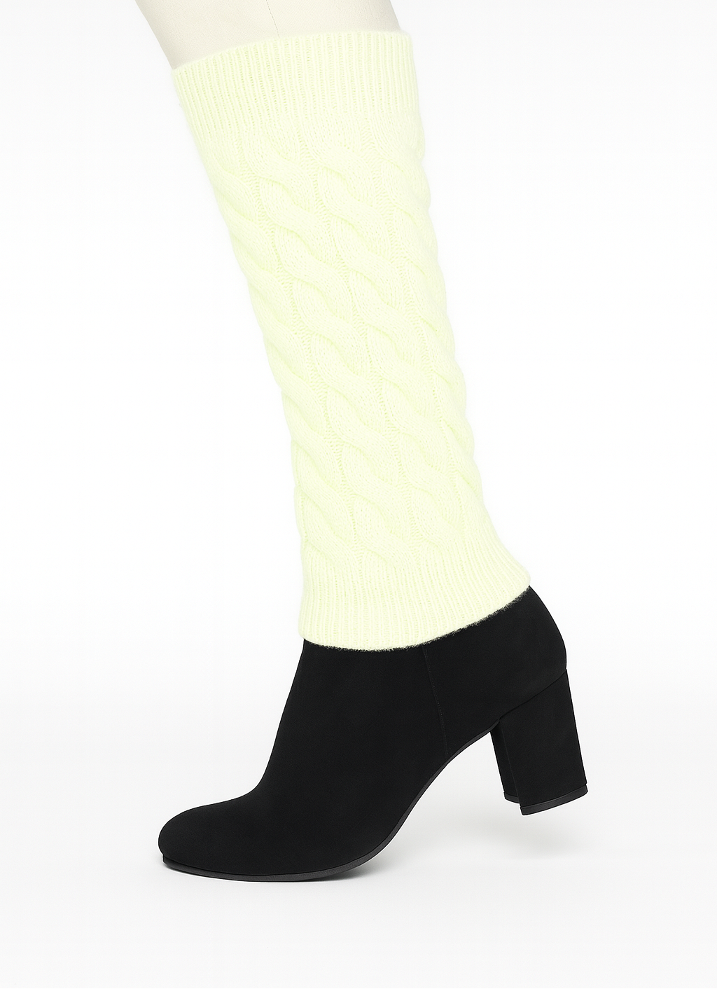 Black ankle boots worn with white tights on a white background