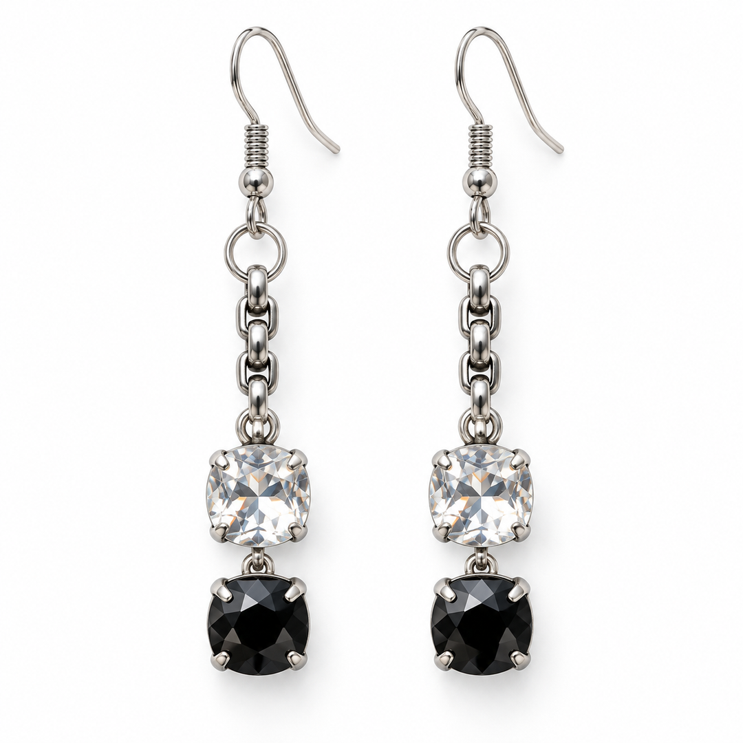 A pair of silver-toned dangle earrings featuring a clear square-cut cubic zirconia and a black square-cut cubic zirconia stone, suspended from a short chain on a white background.