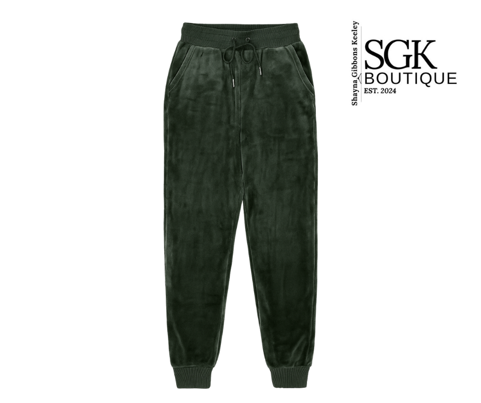 Dark green velvet jogger pants on a white background with SGK Boutique logo.