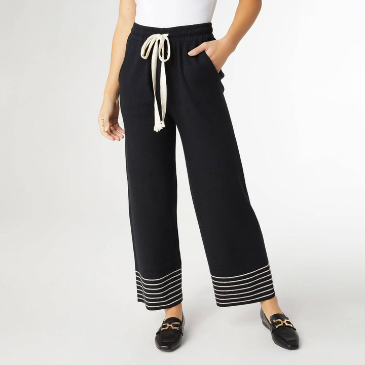 Black pants with white drawstring and trim on a white background